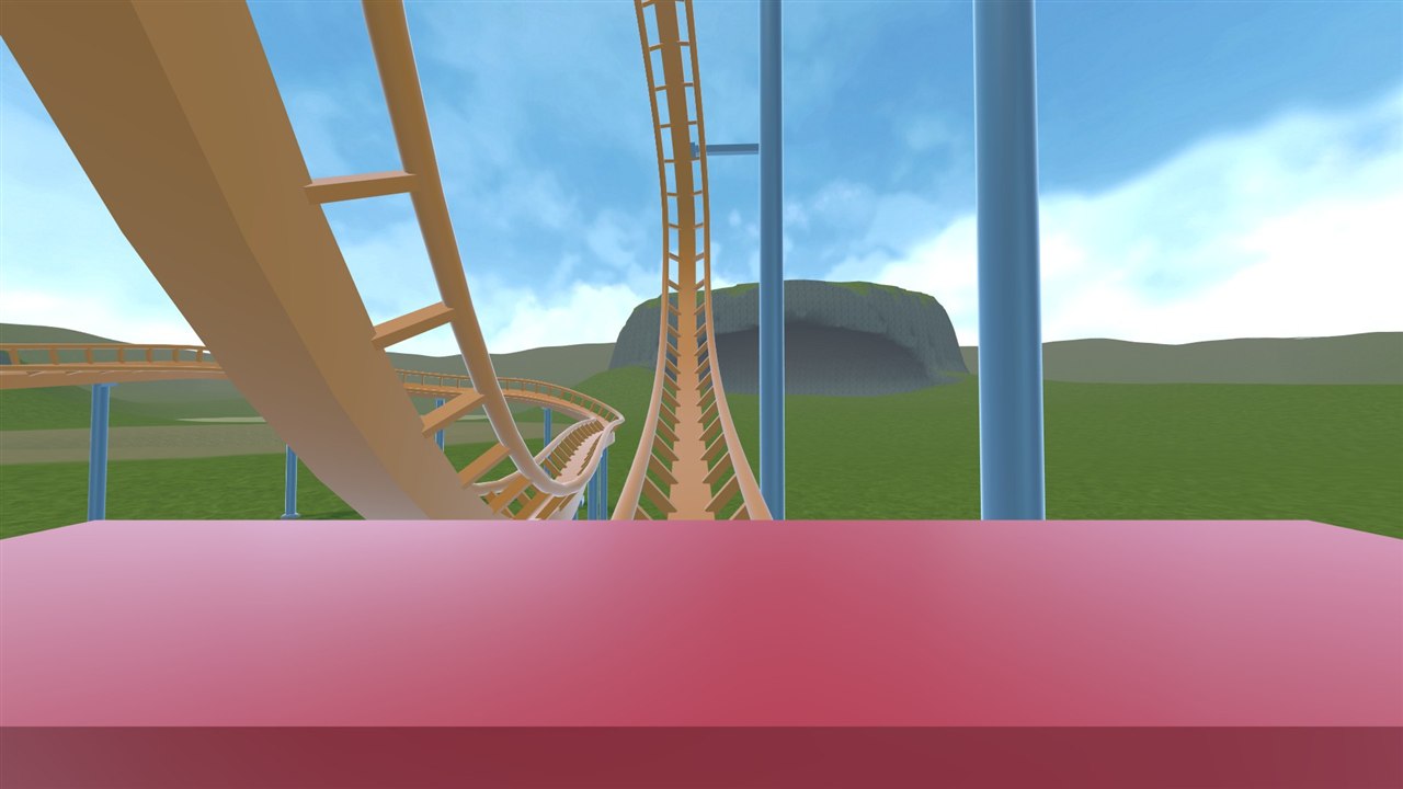 First-person view from the front seat of a steel coaster, looking down the track toward a vertical loop